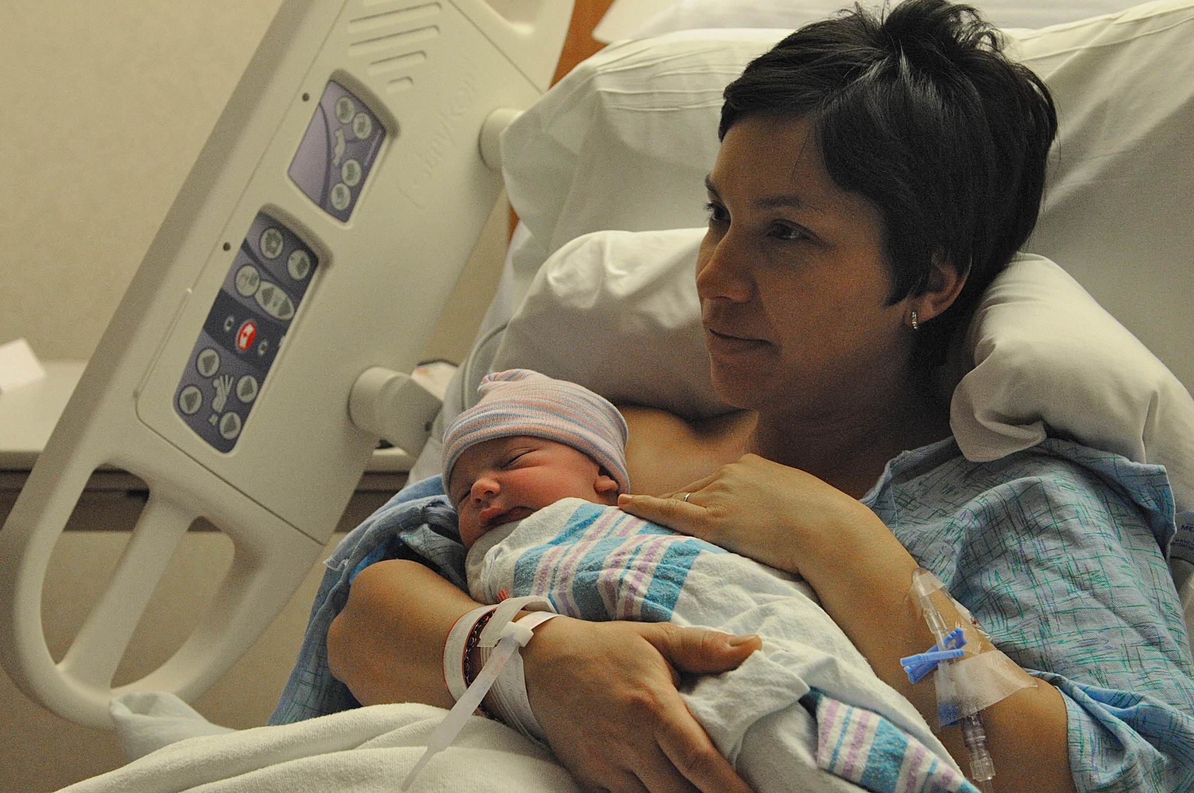 a woman holding a baby in the hospital