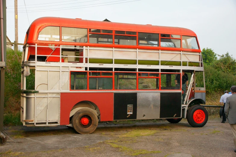 an old double decker bus is sitting on display