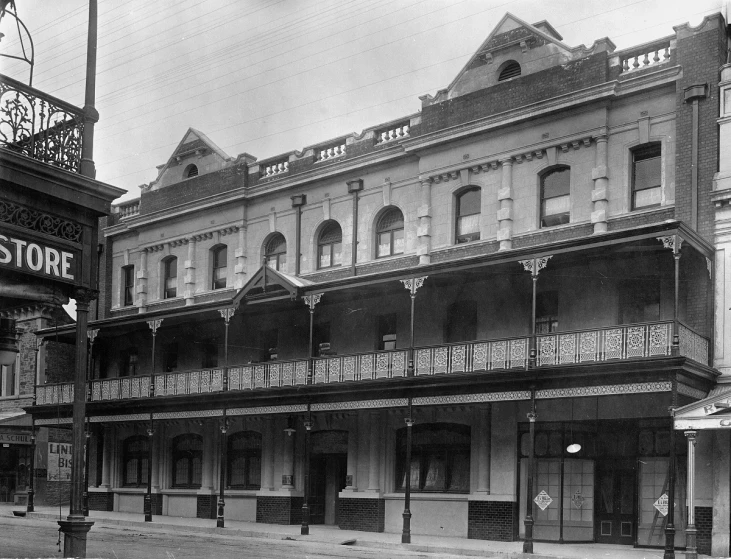 a black and white image of old storefronts and a street