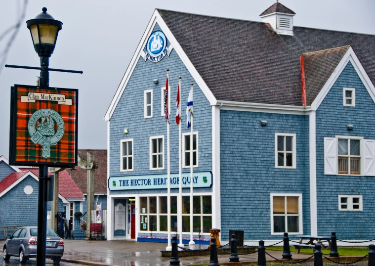 blue colored building with white trim on an oceanfront street