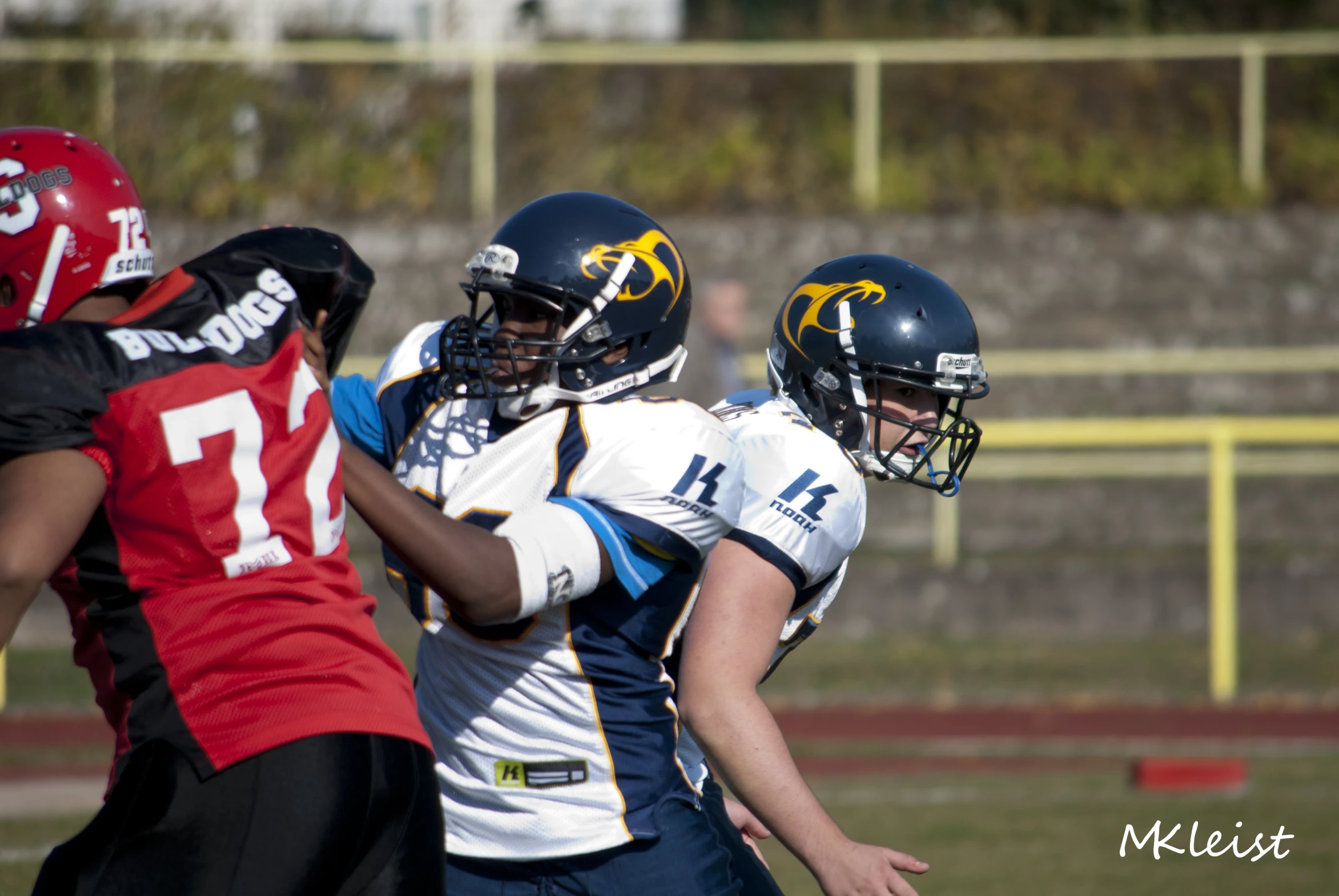 two football players on the opposing team hugging