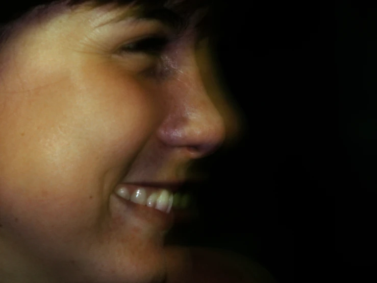 a woman smiles and appears to be wearing silver necklace