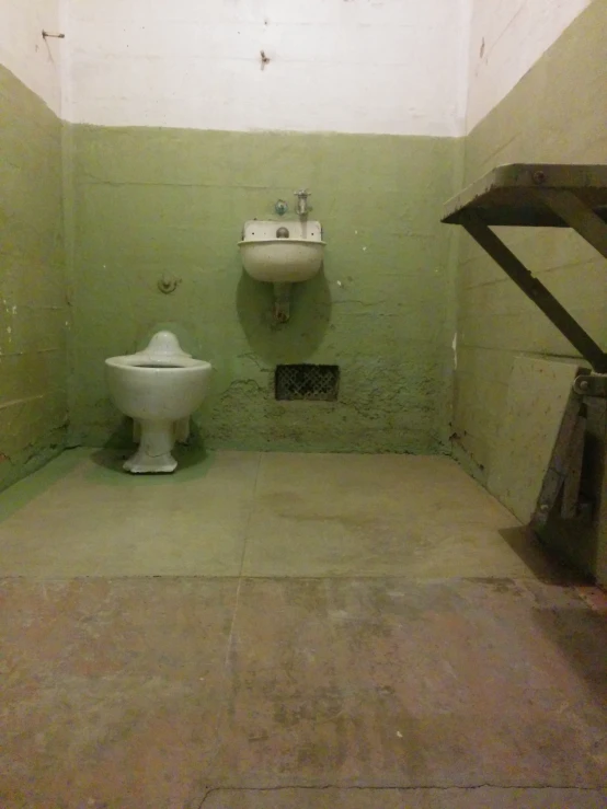 a toilet and a sink in an old building