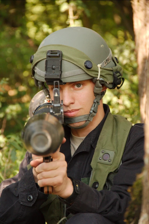 a person with a helmet is holding a gun