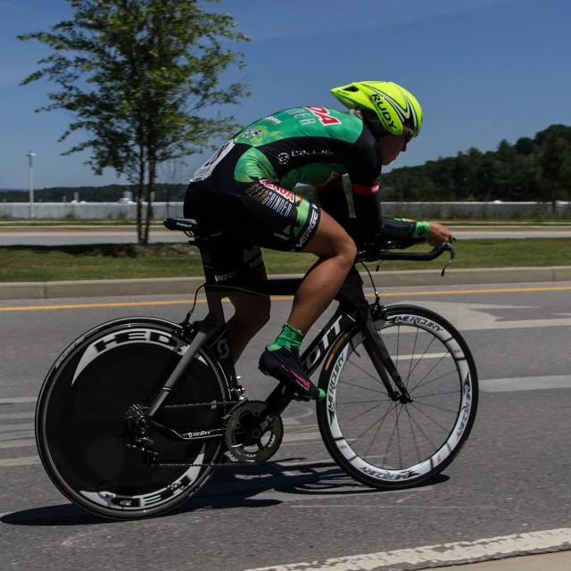 a man in bike gear is riding down a street