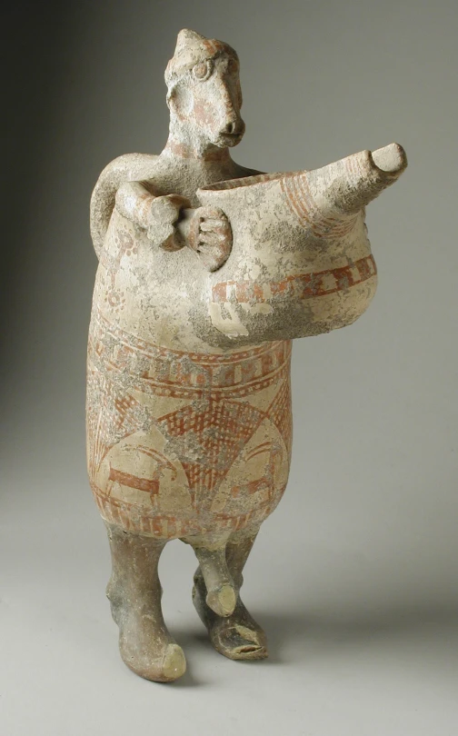 an old vase that is shaped like a figure