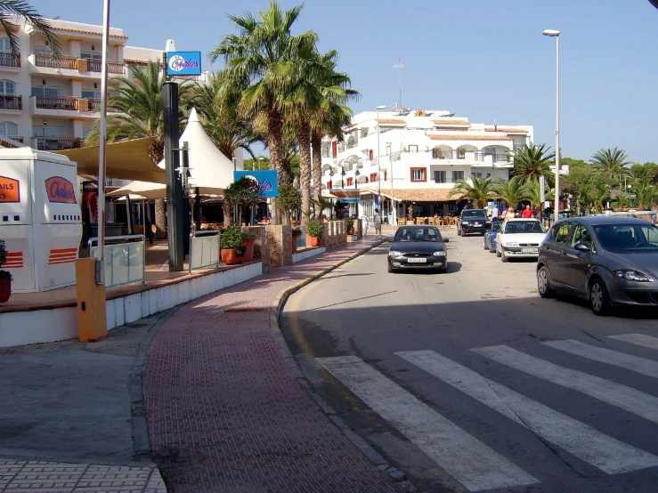 a city street is shown with cars driving through it