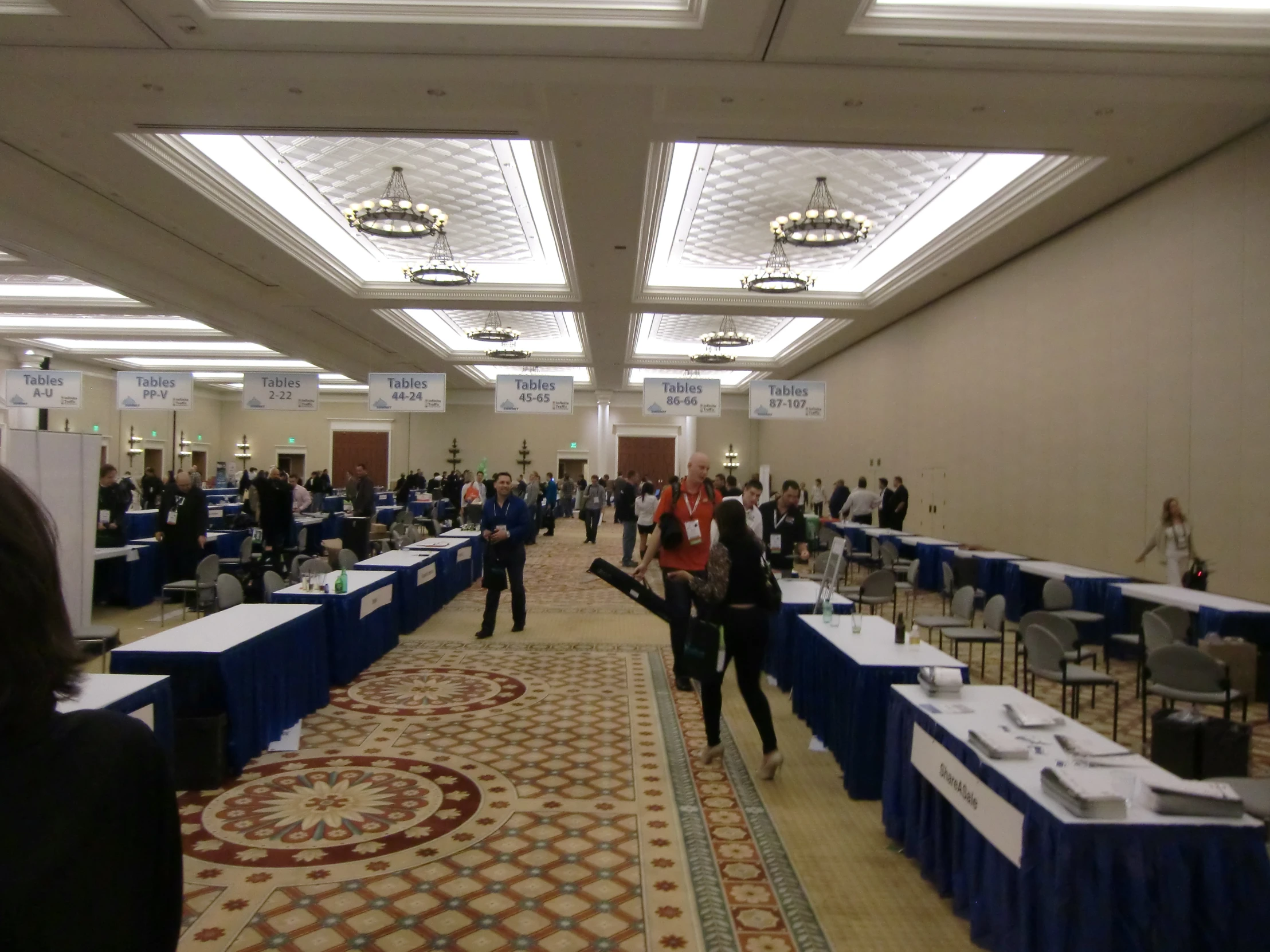 the crowd is gathered in the cafeteria with large tables