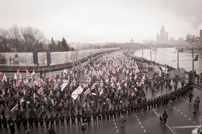 a bunch of people that are holding flags