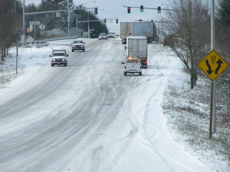 four snow plowed cars in traffic on the road