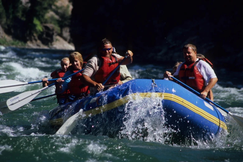 group of people riding in rafts on a river