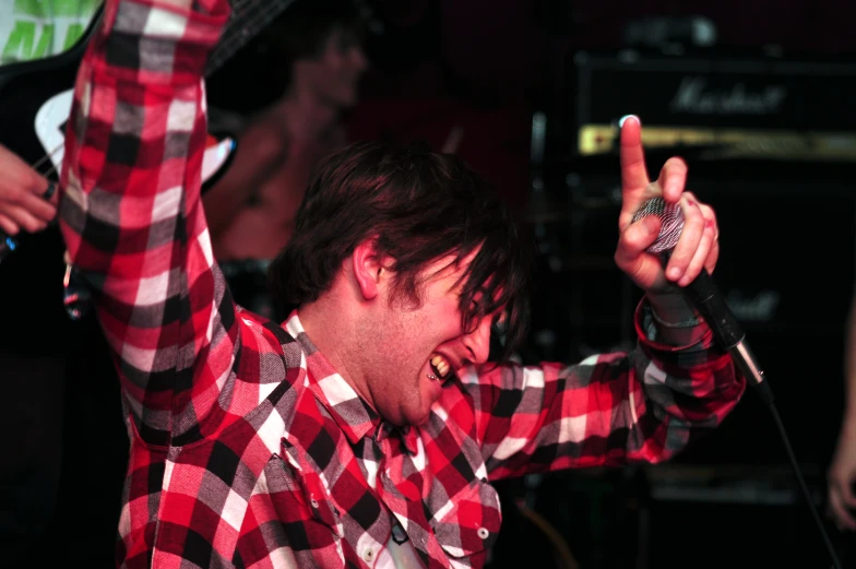 a guy with his hands up in a concert