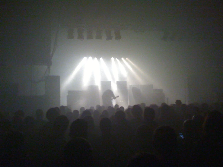 an image of people in front of a concert stage