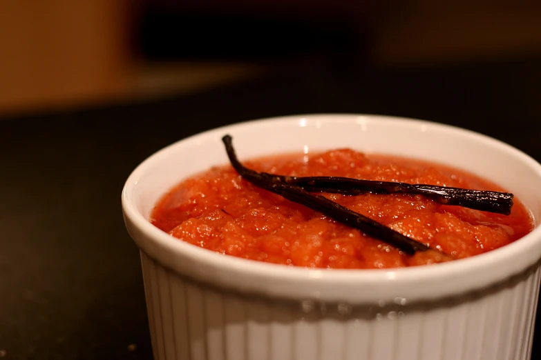 a small bowl filled with food sitting on top of a table