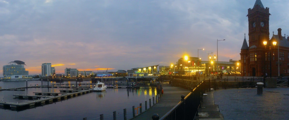 a city lit up at dusk and along the water