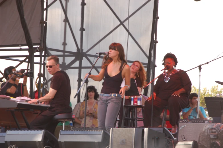 group of people standing and singing on a stage