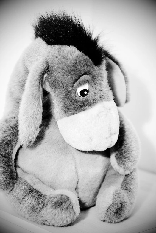 a stuffed donkey sitting on top of a table