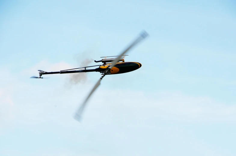 a helicopter flying in the sky with two propellers