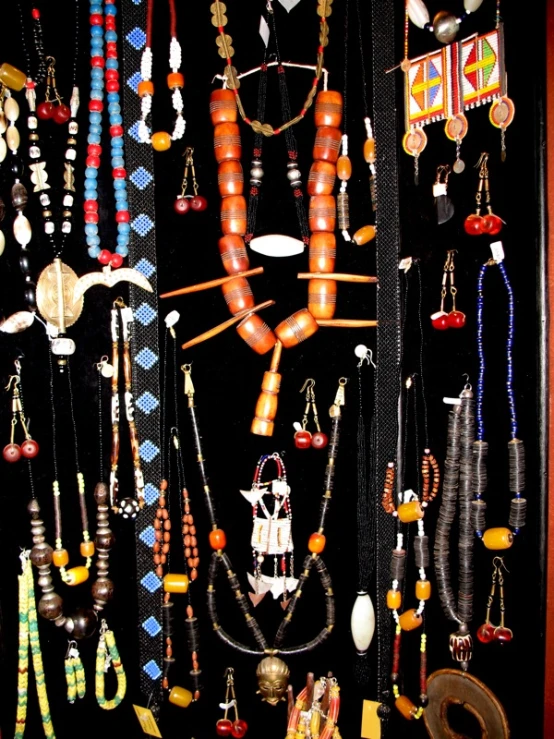 a picture of various pieces of jewelry hanging from a wall