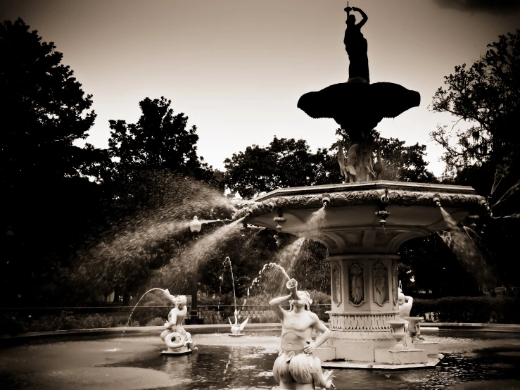 this black and white po is of children playing in the water fountain