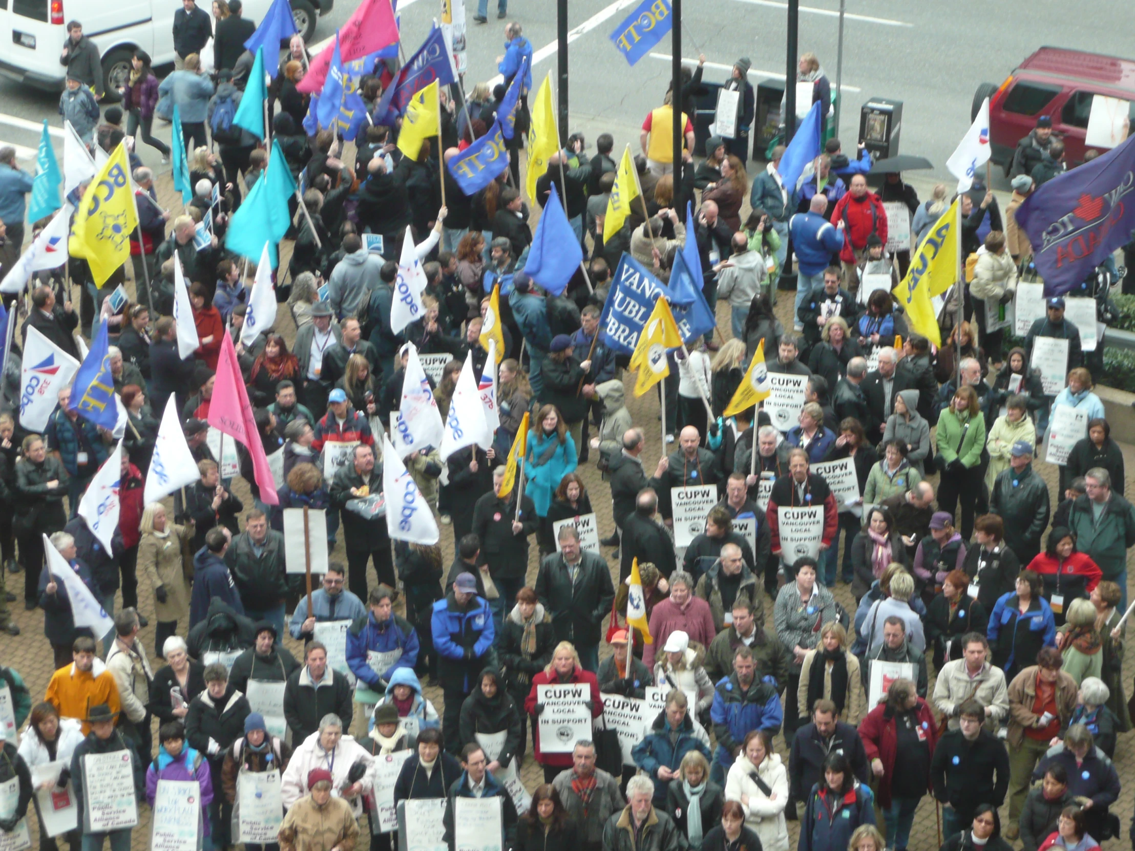 the protestors are onlookers holding up their signs