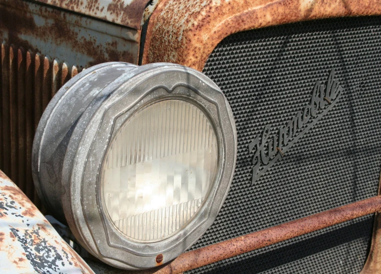 an old, rusty car has a light on top