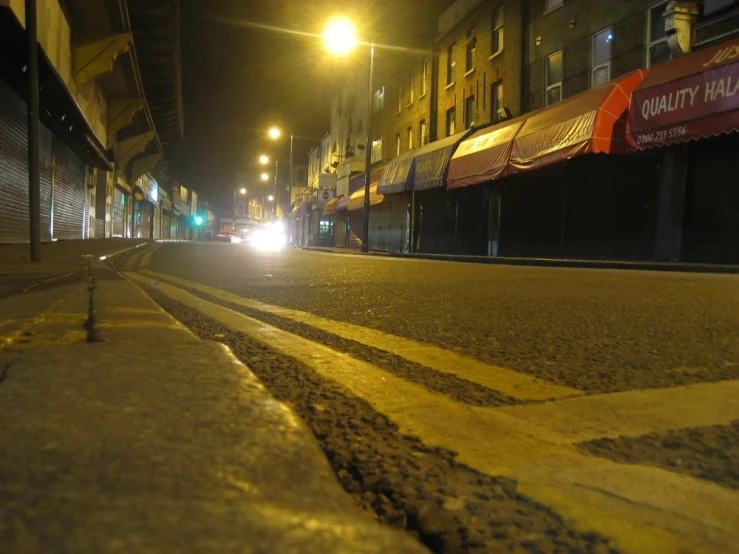 street scene with an almost empty city road and cars on it