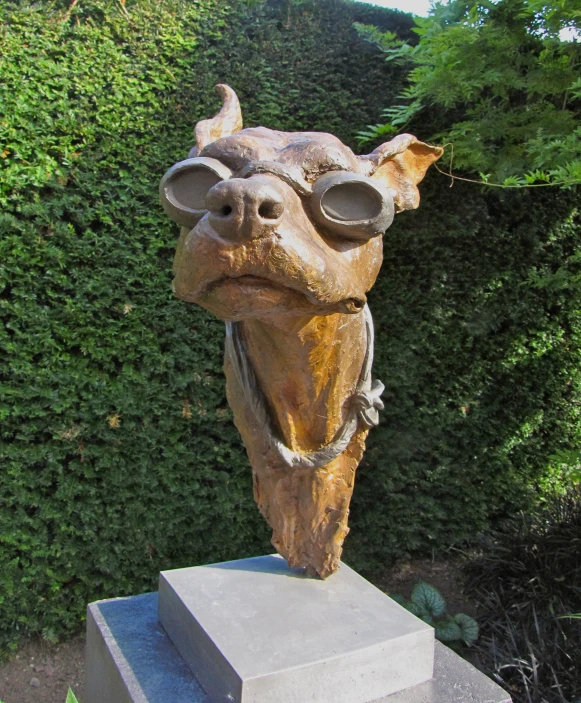 a sculpture of a creature made of stone with very large eyes