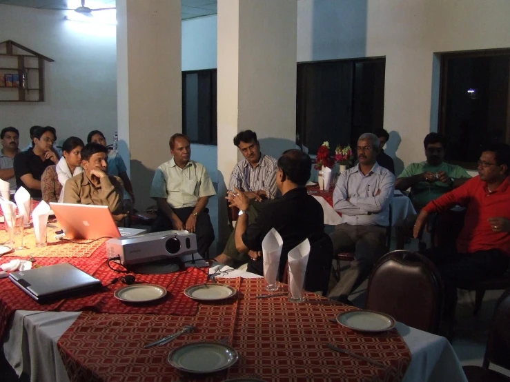 a group of people sitting at tables in a building