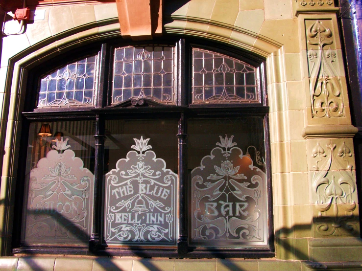 a building with large glass doors and carvings on them