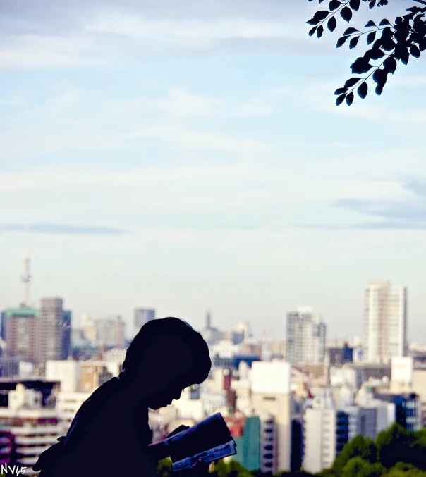 the shadow of the man is standing in front of a cityscape