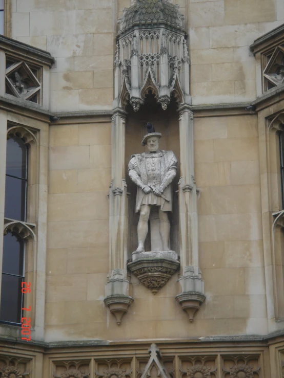 a statue of a man standing on the side of a building