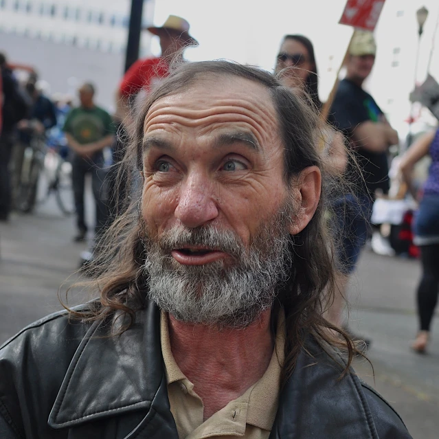 a man with long hair and a moustache