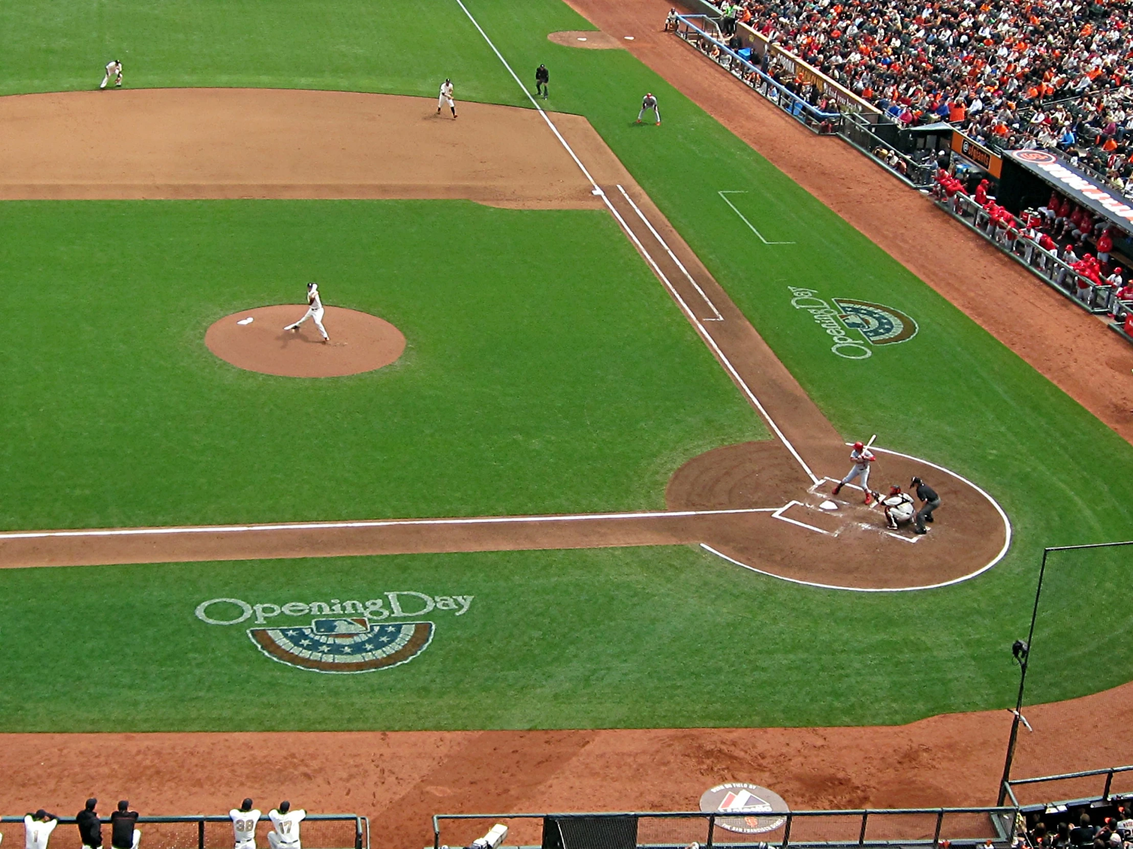 people are watching an baseball game on a field