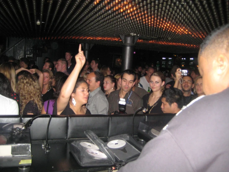 a large crowd in a nightclub is dancing