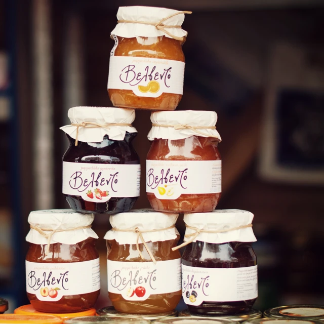 some jar of honey and honey labels sitting on a table