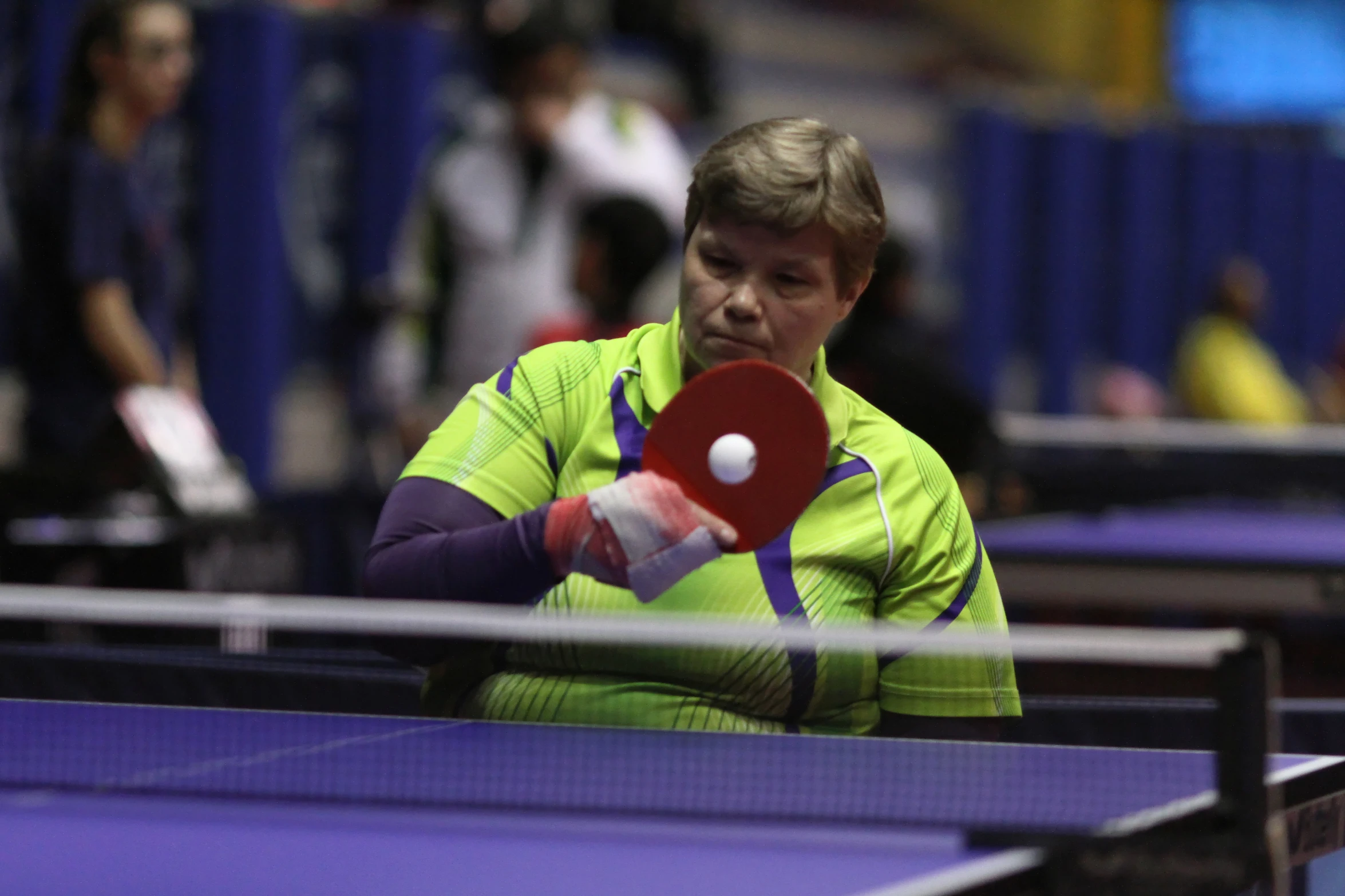 there is a woman that is playing table tennis