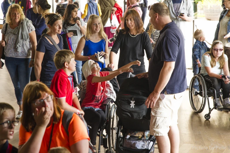 a group of people with wheelchairs walking in line