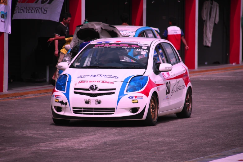 an image of a rally car driving down the road