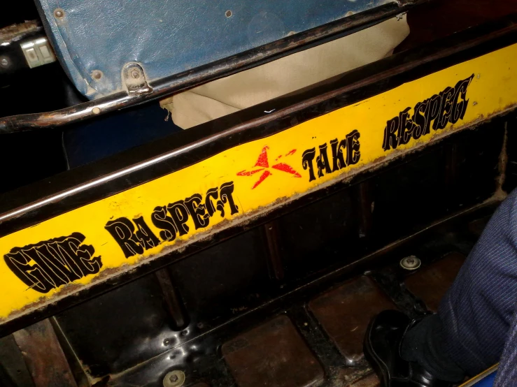 an industrial yellow and black sign reading one respect to railroad workers