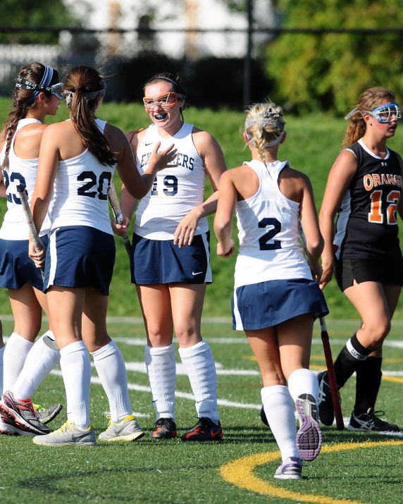 women's soccer players huddle in a huddle before a game