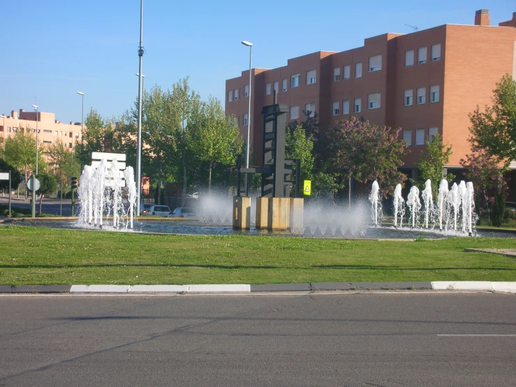 a street corner with fountains and buildings in the background