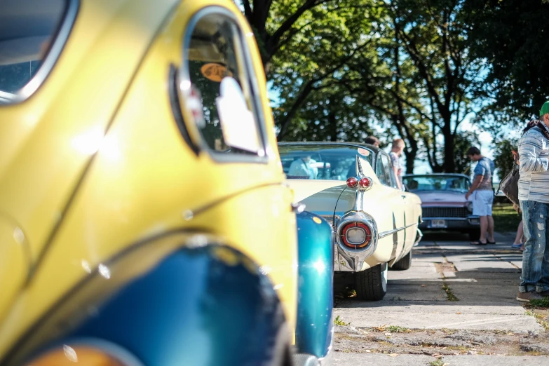 people viewing classic cars at an antique car show