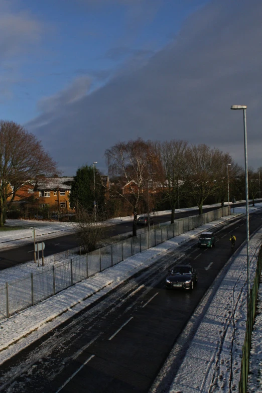 the traffic is traveling along a snowy road