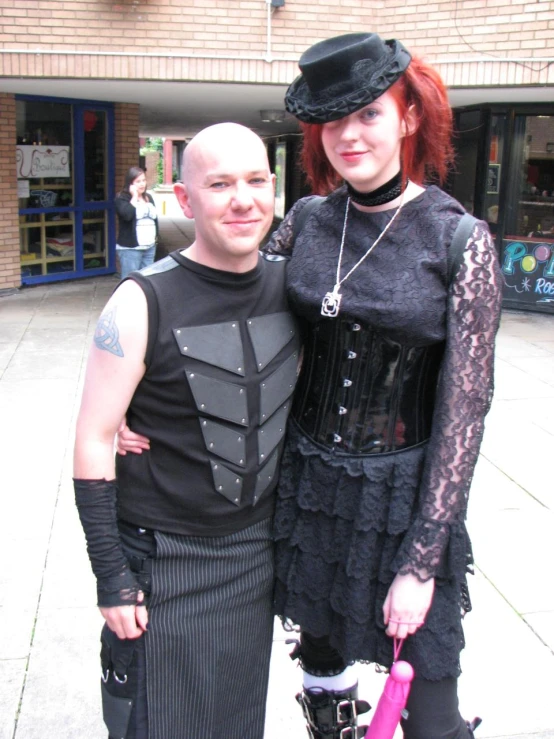 a man and woman in costume posing for a po