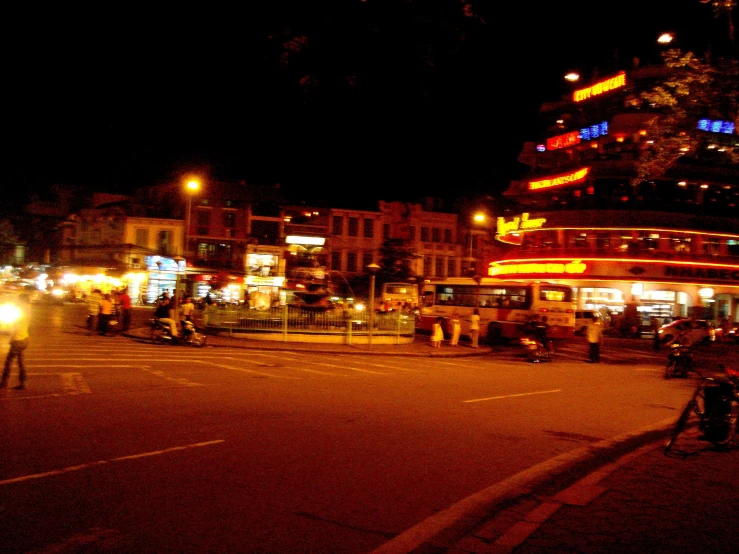 a city street filled with traffic at night