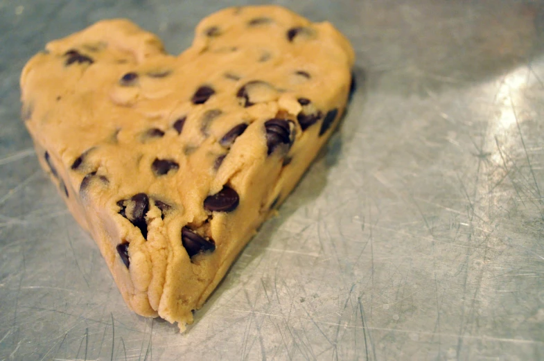 a heart shaped cookie on top of a table