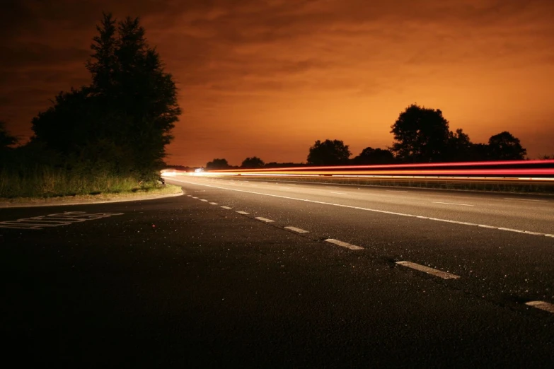 a highway is lit with streaks as the sun sets