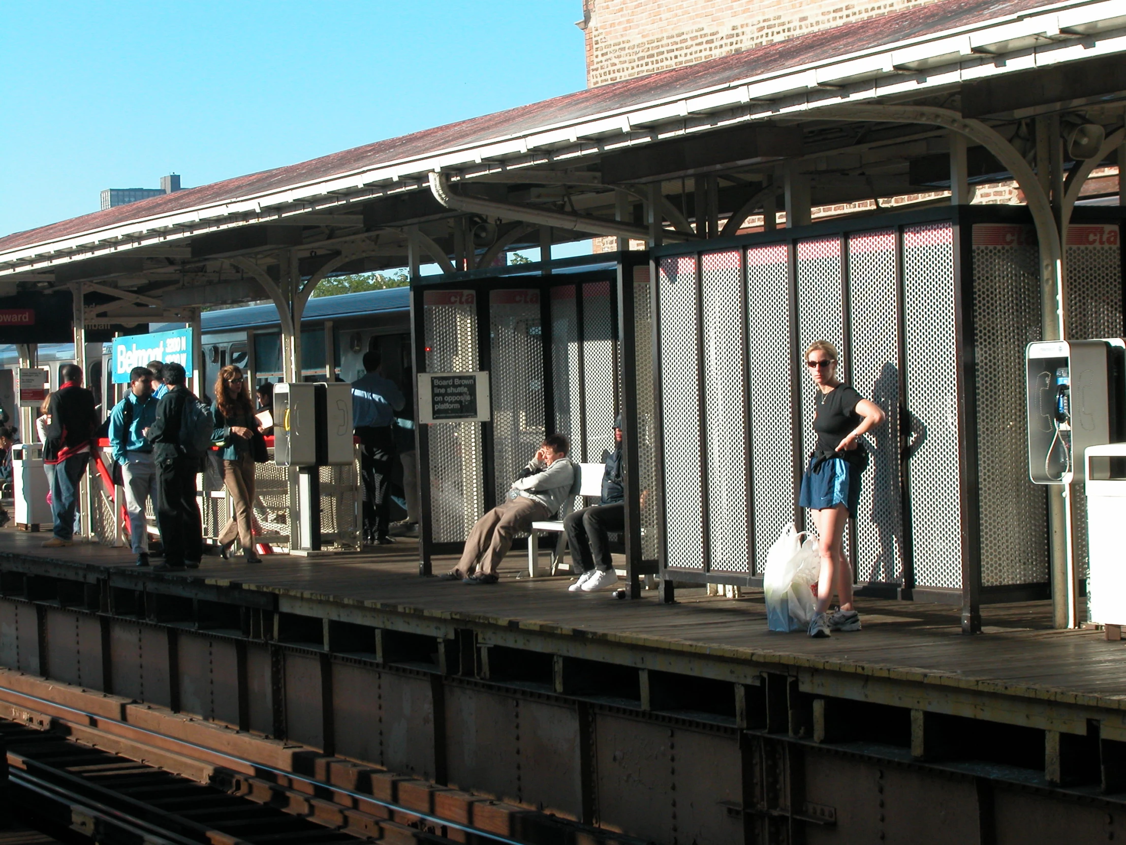 passengers wait for the train to arrive on the platform