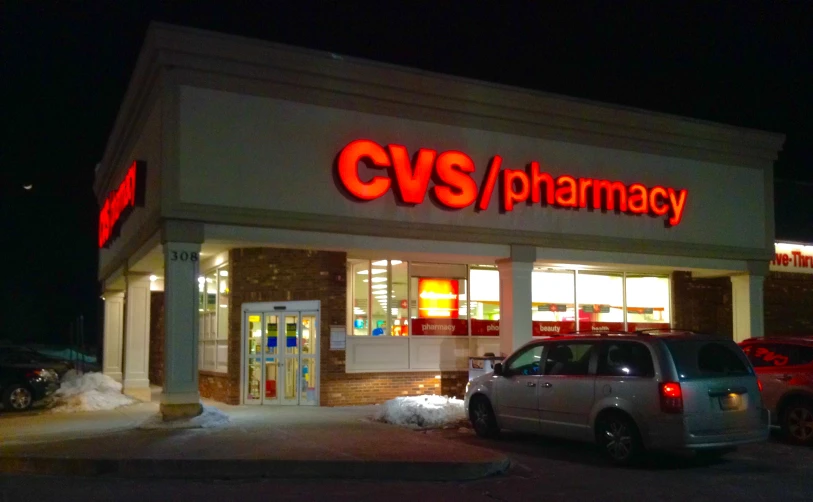 a pharmacy that is lit up at night